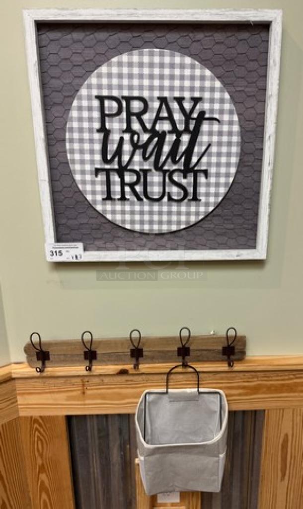 Decorative wall picture with "Pray Wait Trust" text, wood rack with four hooks, and hanging fabric magazine holder. Excellent condition.