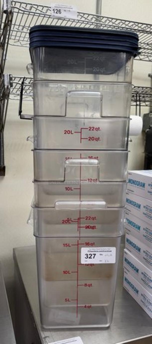 6 clear 22 Qt. square containers with measurement markings and 4 lids, stacked. Ideal for kitchen storage.