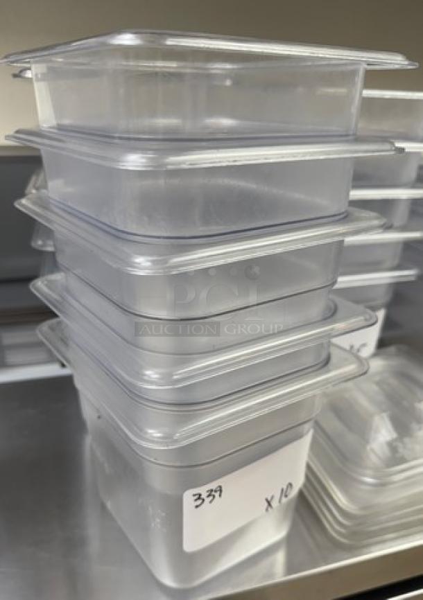 Stack of Vigor acrylic pans, 1/3 x 6 size, clear, lightly used. Label reads "339 x10." Suitable for catering or restaurants.