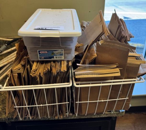 Lot of new sealable paper bags in two wire baskets with storage container. Ideal for packaging. Excellent condition.