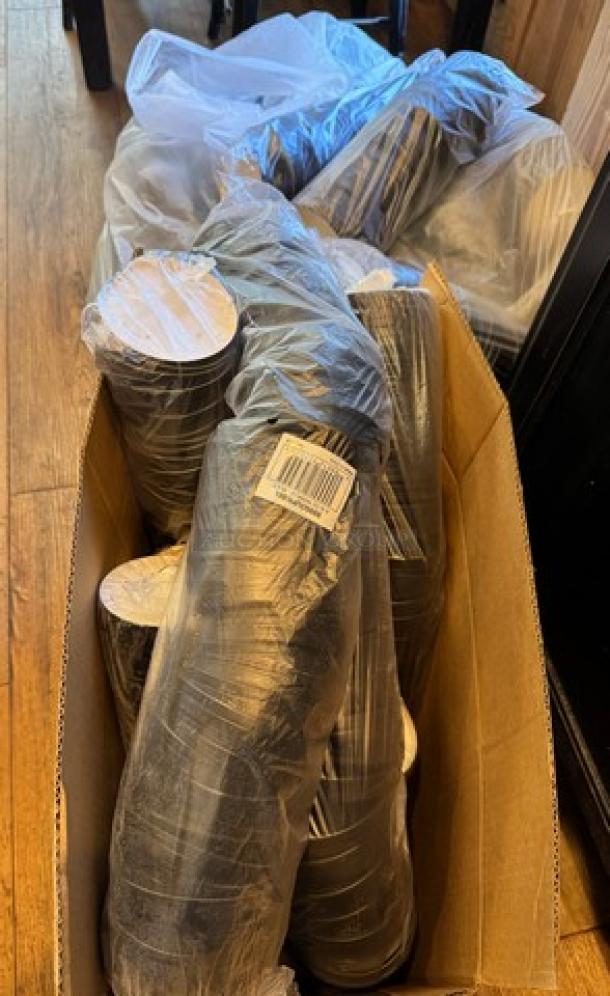 Bulk pack of new lids for soup or chili bowls, sealed in plastic, stacked in a cardboard box. Ideal for restaurant use.