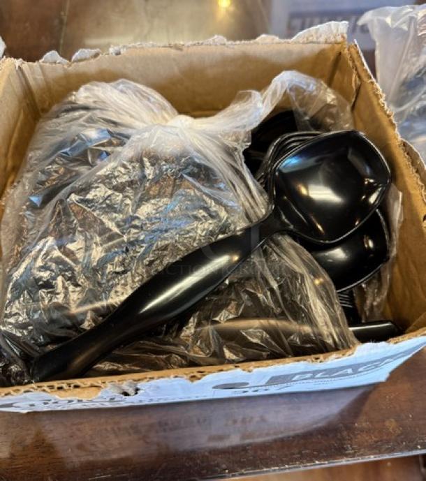 New black 8.5" plastic serving spoons, box of 50, in original packaging, perfect for catering or events.