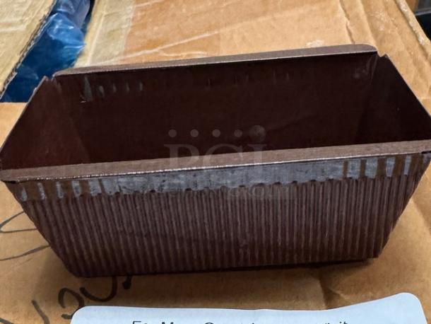 Disposable mini loaf pan with a ribbed texture, brown color, and rectangular shape; ideal for baking small loaves.