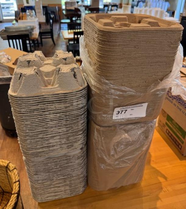 Take Out Cup Holder Trays, stack of paperboard, sturdy design, item labeled "377," bulk quantity, ideal for beverage transport.