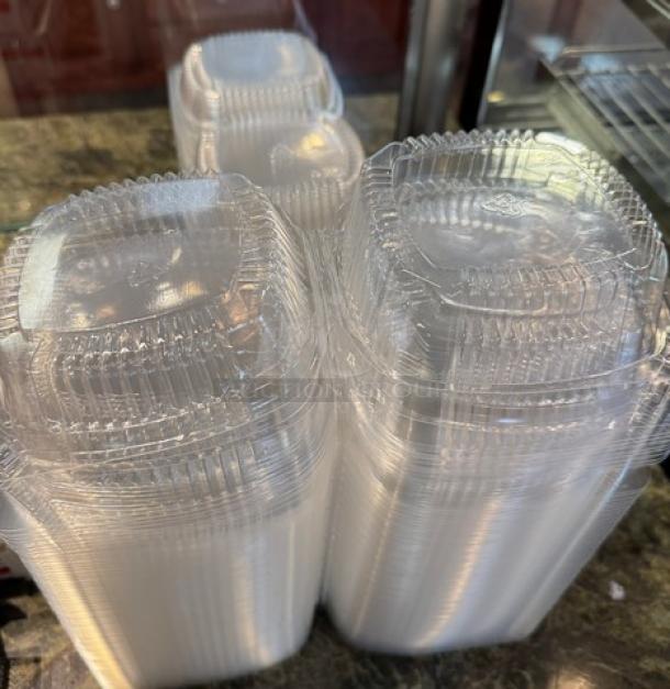 Stack of small clear plastic take-out containers, nested, glossy finish, ideal for food storage or takeaway.