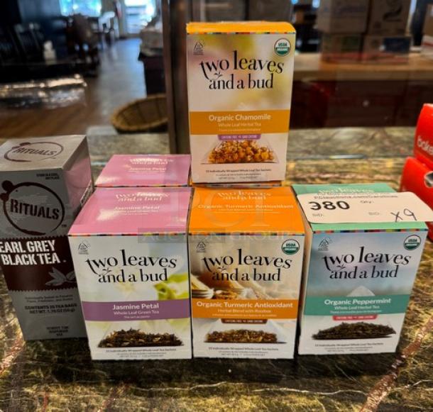 Assortment of Two Leaves and a Bud teas: Earl Grey, Black, Jasmine, Peppermint, Organic Turmeric Chamomile; boxes displayed on a counter.