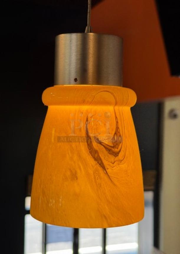 Amber glass pendant light with metallic fixture, 4.5" x 7". Elegant swirl design, modern style, set of five available.
