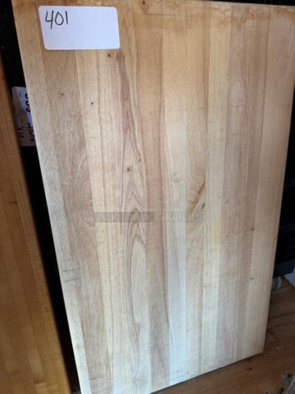 Large wooden cutting board with light wood grain, rectangular shape, minimal wear. Label marked "401."