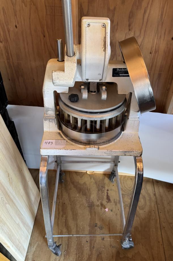 Duchess BMIH dough press on casters, metal frame, used condition, visible label, ideal for bakery use.