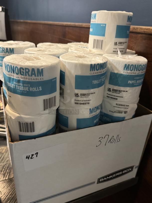 37 Monogram toilet tissue rolls in box, brand-new, 2-ply, 500 sheets each. Labels show product details and origin.