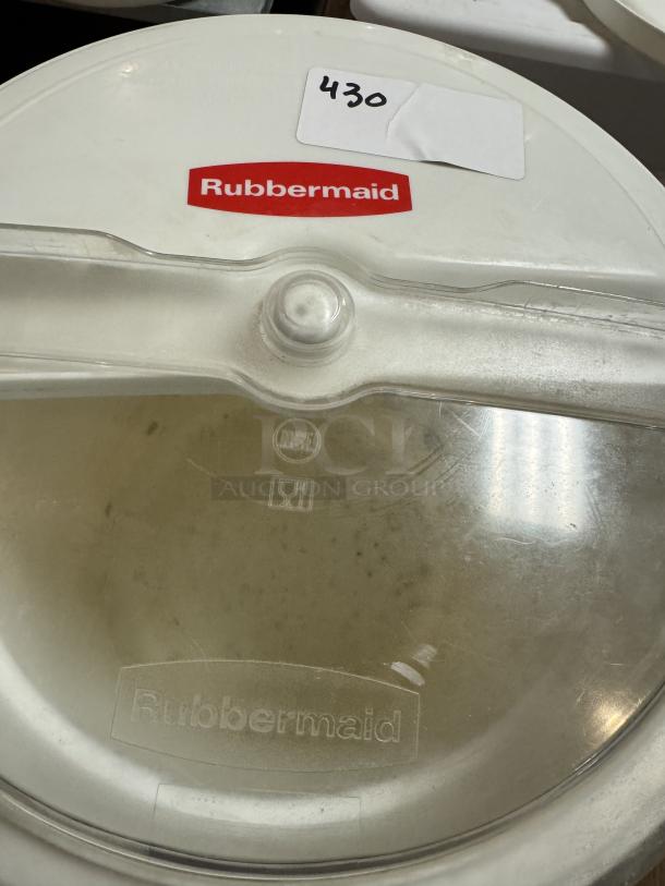 Rubbermaid Brute 10 Gal dry storage container with sliding lid. Features logo and label; used condition with some wear.