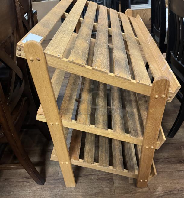 Wooden display rack with 3 slatted shelves, natural finish, sturdy condition. Ideal for storage or decorative use.
