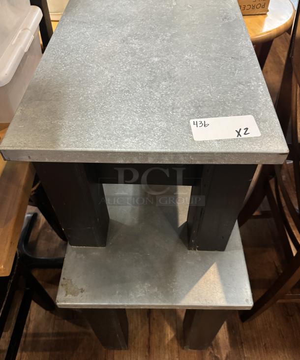 Two black tables with metal tops; sizes 30x17x23 and 23x17x14 inches. Condition indicates mild use. Tag reads "436 X2".