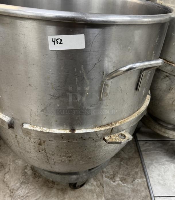 120 Qt. stainless steel mixing bowl with dollie, visible wear and minor rust on rims. Label with number 452 attached.