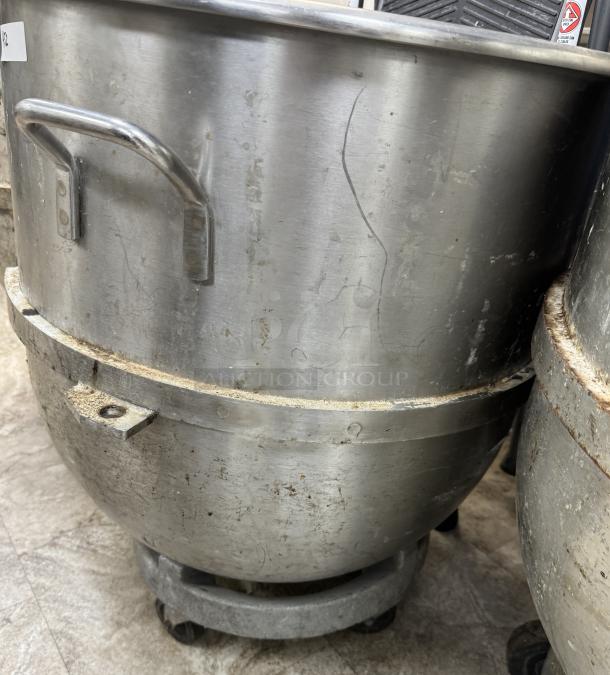 120 Qt. mixing bowl with dollie, stainless steel, visible wear and surface scratches, sturdy handle, industrial use.