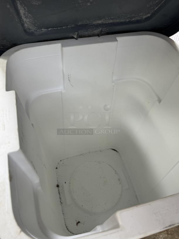 Rubbermaid 40 gal dry storage container, white, open, interior view; includes dollie. Some dirt on the interior base.