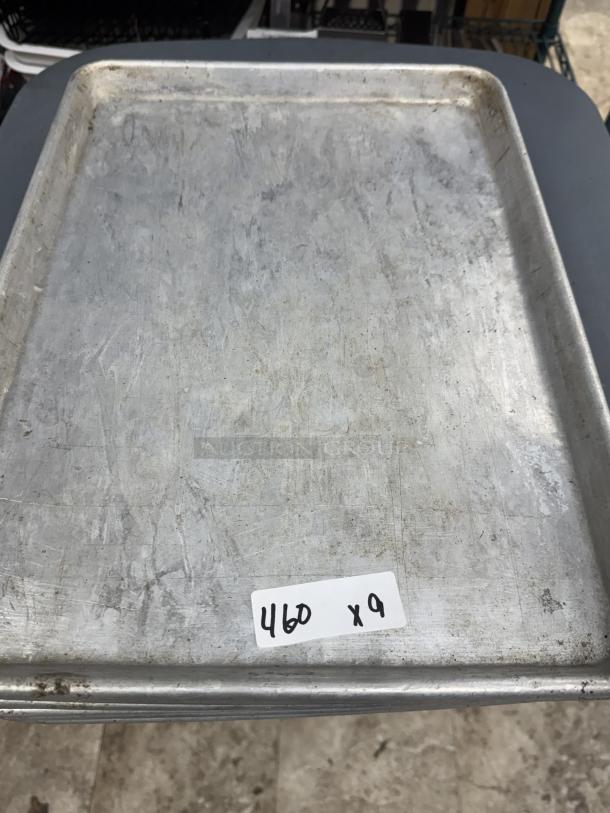 Half size sheet pan, used condition, metallic surface with visible marks, labeled "460 x 9" indicating quantity for auction.