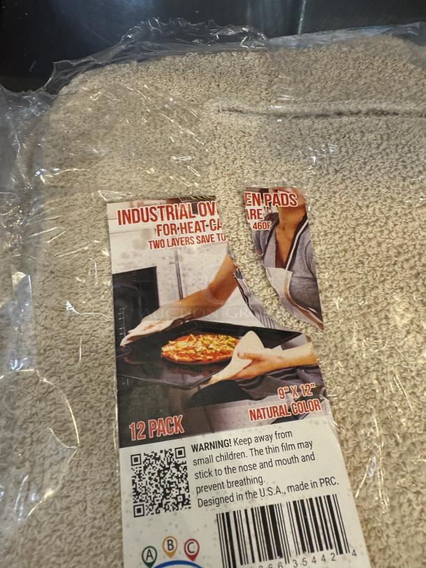 Industrial hot oven pads, 12-pack, 9"x12", natural color, heat protection up to 460°F. Packaged with safety warning label.
