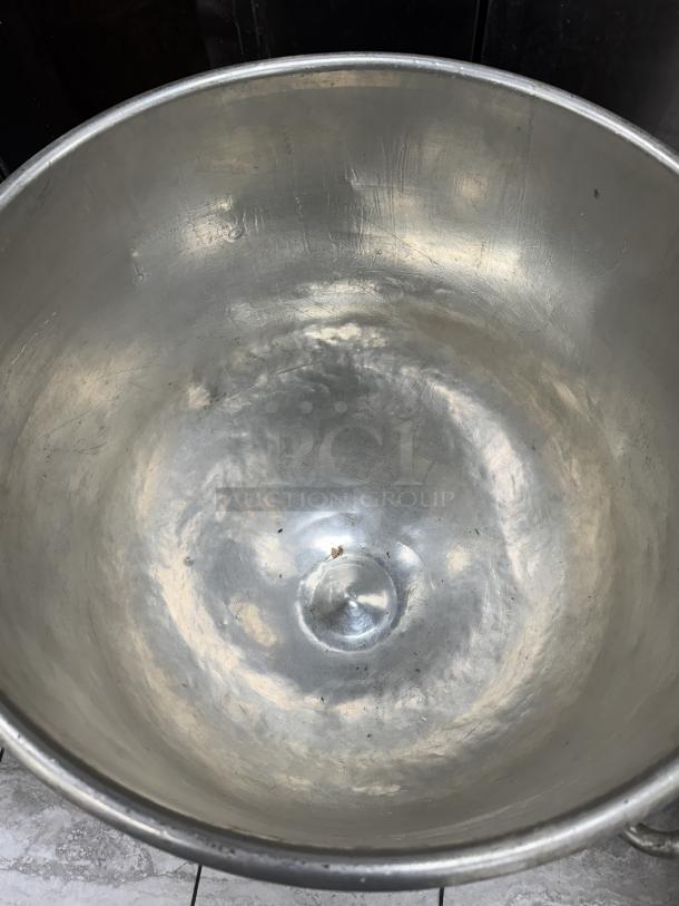 128 Qt. stainless steel mixing bowl, interior shows signs of use, comes with dollie, ideal for large batch mixing.