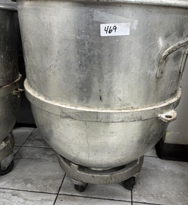128 Qt. mixing bowl with dollie, showing signs of wear. Metal finish, numbered tag 469. Ideal for large batch mixing.