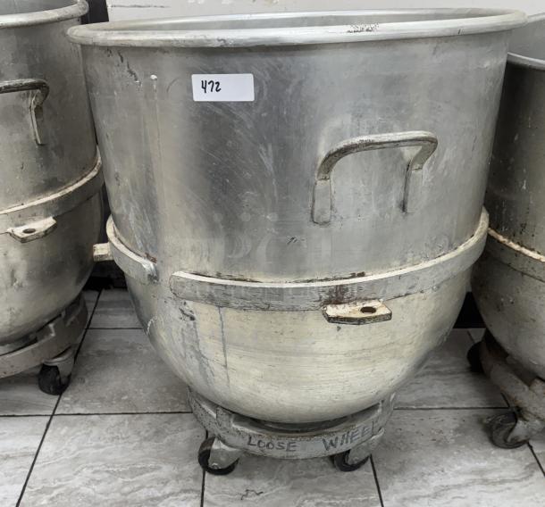 128 Qt. mixing bowl with dollie, made of metal, handles on sides, used condition, label "472" affixed, loose wheel noted.