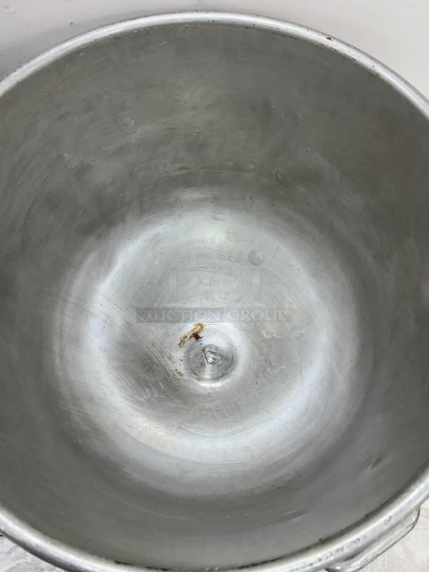128 Qt. mixing bowl with visible wear and small rust spot, includes dollie for mobility, ideal for large kitchen operations.