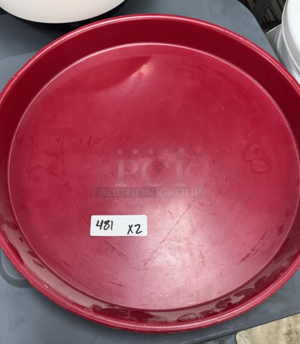 Red 16" round serving tray with slight wear, auction lot tag "481 x2." Set of two trays.