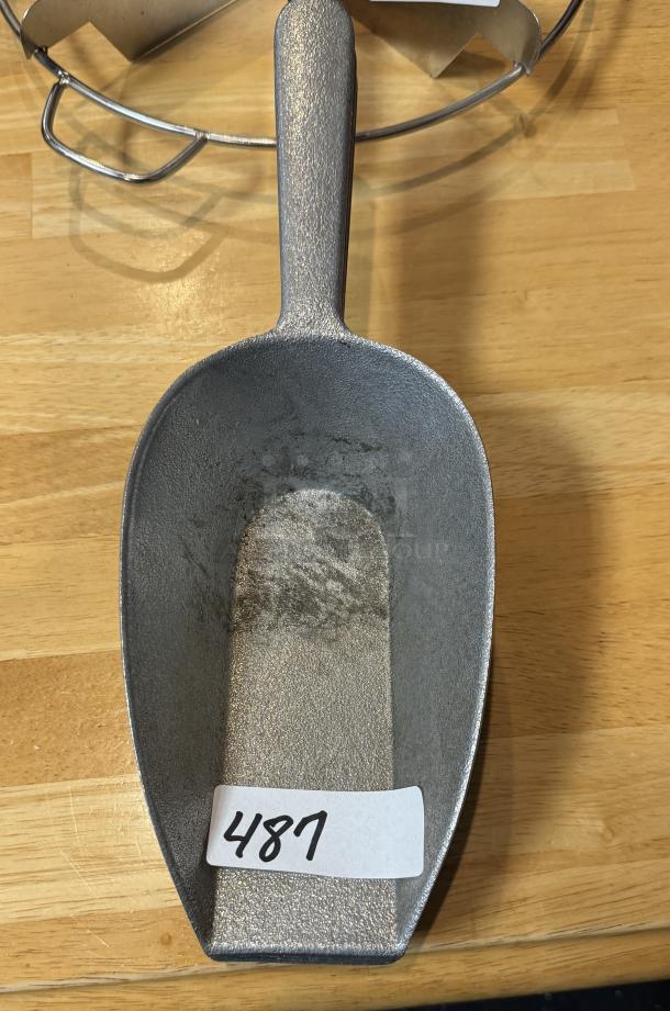 16 oz metal scoop with handle, showing light wear. Number 487 tag displayed, auction lot of three scoops.