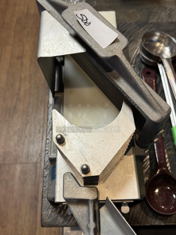Nemco slicer with metallic finish, showing blades and levers; condition appears used. Price tag visible with "50."