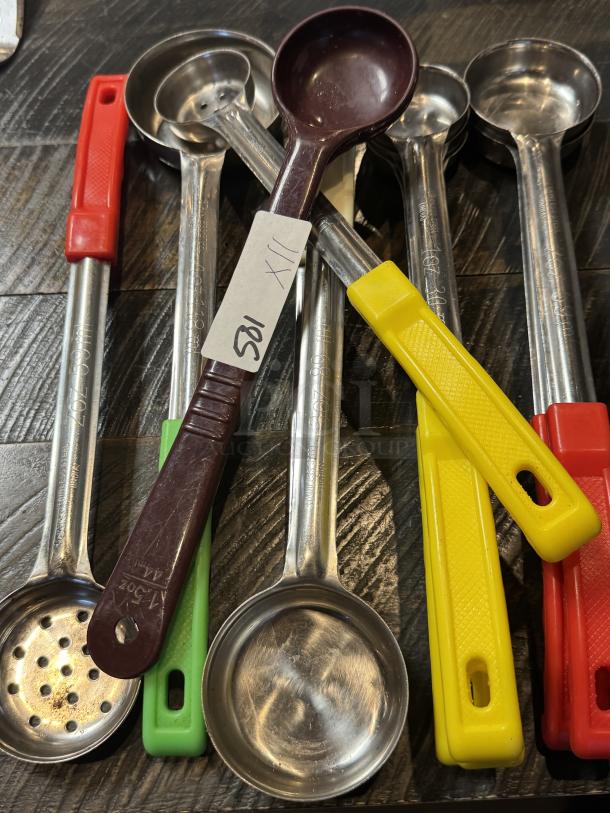 Assorted serving ladles with colored handles and stainless steel bowls. Includes slotted and solid designs. Item tag visible.