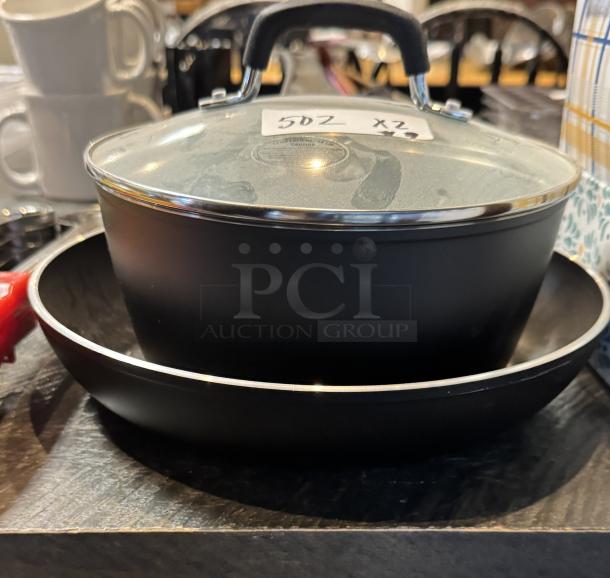 Tramontina 10" frying pan and 2.75 qt. sauce pan with lid, black finish, heat-resistant handles, new condition, visible markings.