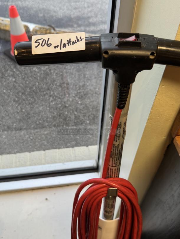Oreck XL Pro Scrubbing Machine with attachments, tested and working. Features a red power cord. Tag reads "506 w/attacks."
