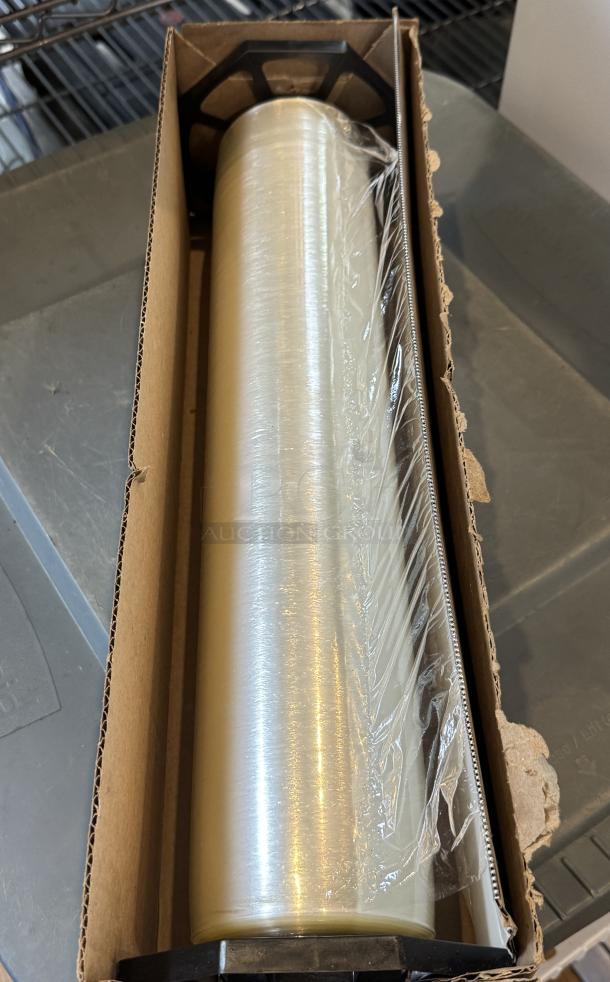 18" plastic film roll in cardboard box, clear and intact. Suitable for packaging, features an easy-cut edge.