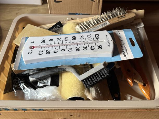 Assorted painting supplies with brushes, rollers, and an Acurite thermometer, new condition, in a plastic tray.