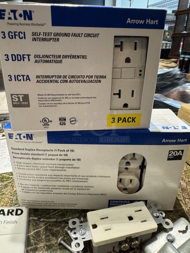 Eaton assorted receptacle covers, new in box, including 3 GFCI interrupters and standard duplex receptacles, unopened.