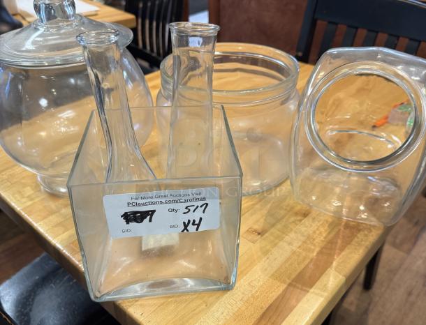 Assorted glass containers, four pieces, various shapes and sizes, clear glass, in good condition, labeled for auction.
