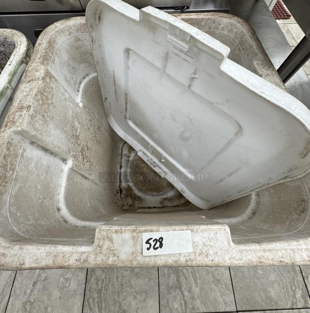 Rubbermaid 40 Gal dry storage container, white, used condition with visible dirt, label marked "528" on the side.