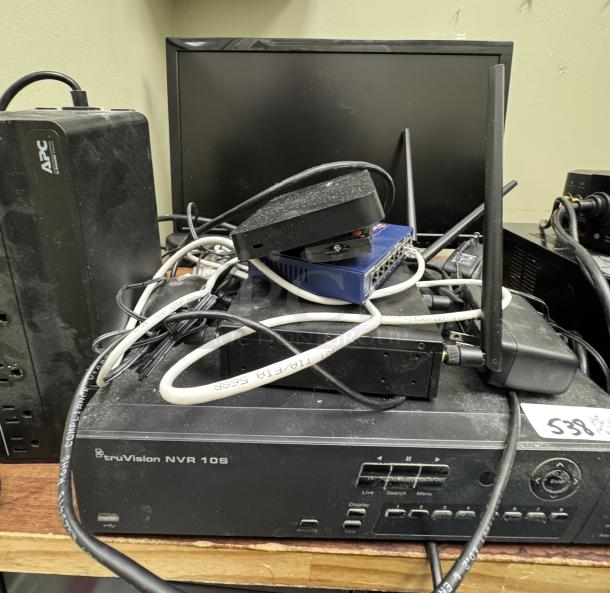TruVision NVR 10S Security System with APC surge protector, cables, and two monitors; tested and working, minor dust present.