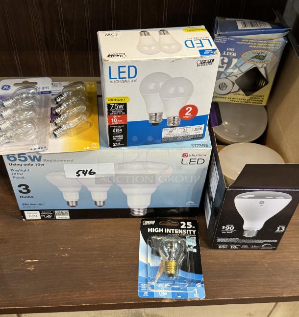 Assorted new light bulbs, including Utilitech LED, GE LED, and 25W high-intensity bulbs. Various types and wattages.