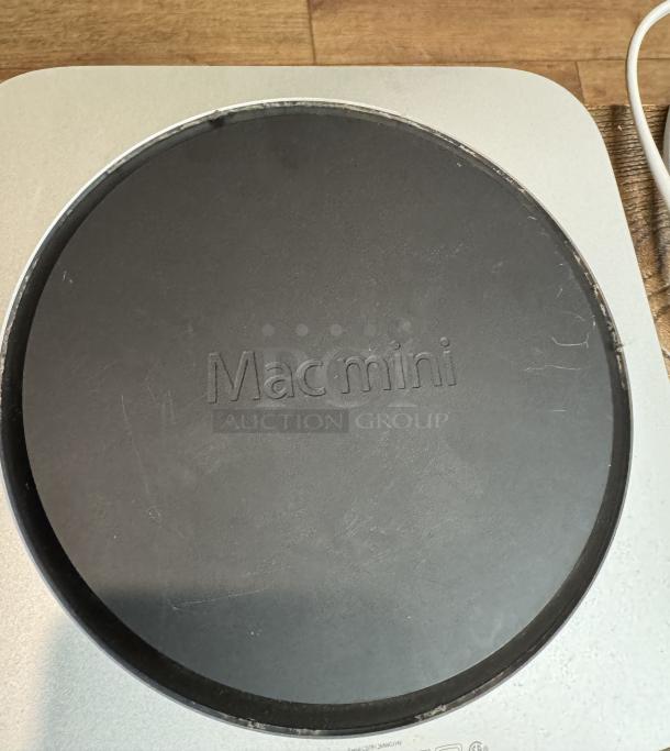 Apple Mac Mini, showing bottom panel with "Mac mini" engraving. Tested and working condition.