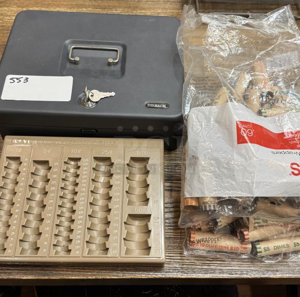 Steel Master cash box with key, beige coin change tray, and various coin wrappers, showing minimal wear.