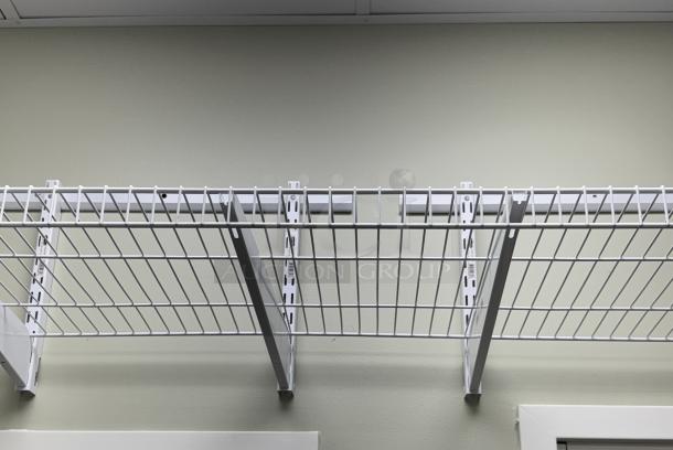 Wall mount wire shelving with white brackets installed on a light green wall, featuring sturdy metal construction in excellent condition.