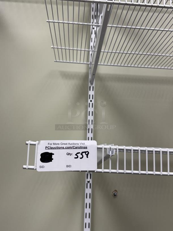 Wall mount wire shelving with brackets, white finish, in excellent condition. Auction tag reads "Qty: 559."