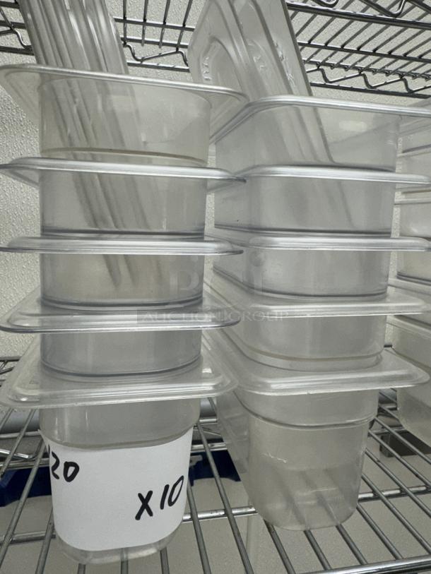 Acrylic 1/6 x 4 pans with 8 lids, set of 10, on metal shelf. Labeled "20 x 10". Clear, stackable, ideal for storage.