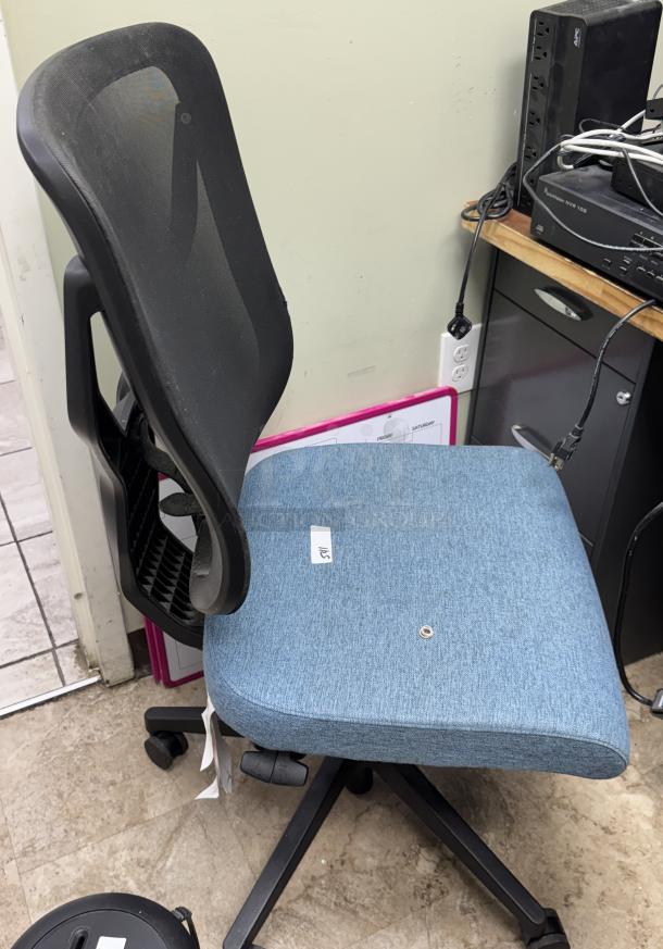Blue swivel office chair with mesh back and fabric seat, on caster wheels. Used condition, with tag labeled "116."