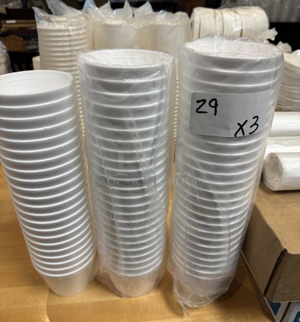 Three stacks of 16 oz styrofoam cups, wrapped in plastic. Label reads "29 x3". Ideal for beverages.