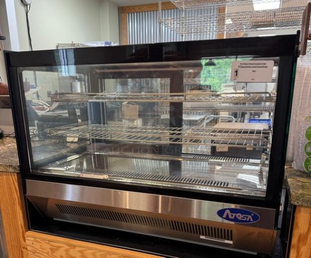 Atosa Refrigerated Display Case, used less than 3 months, tested and working, stainless steel finish, glass front, shelving inside.