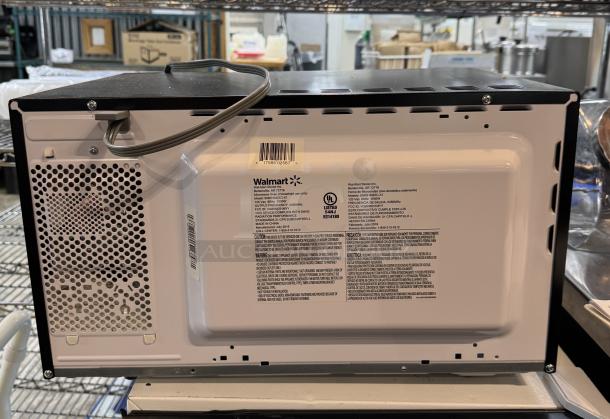 Hamilton Beach Microwave, Model EM031M22C-X1, 1500 W, back view with label showing specifications and Walmart branding.