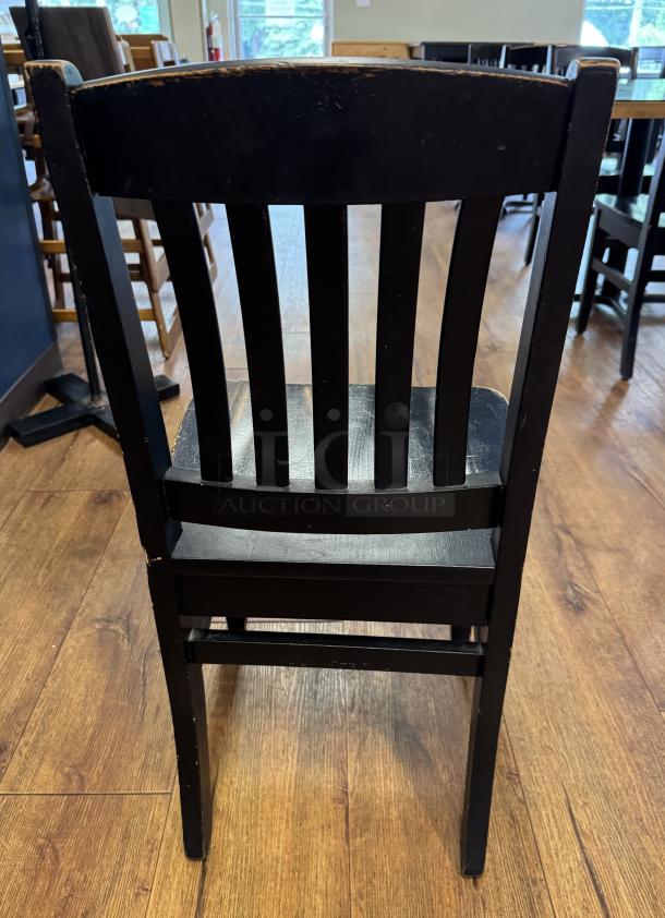 Set of 6 black dining chairs with slatted backs and visible wear. Suitable for dining or kitchen use. Good condition.