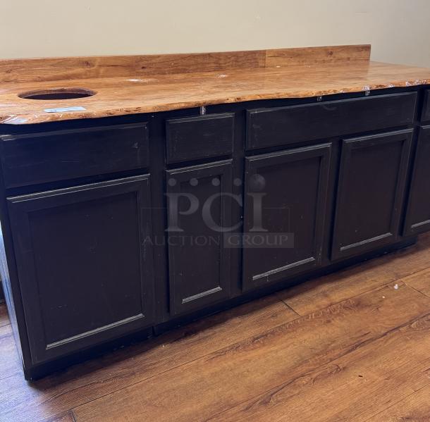 Wooden display/storage cabinet with four doors, tabletop cutout for trash, and a rustic wood countertop. Good condition.